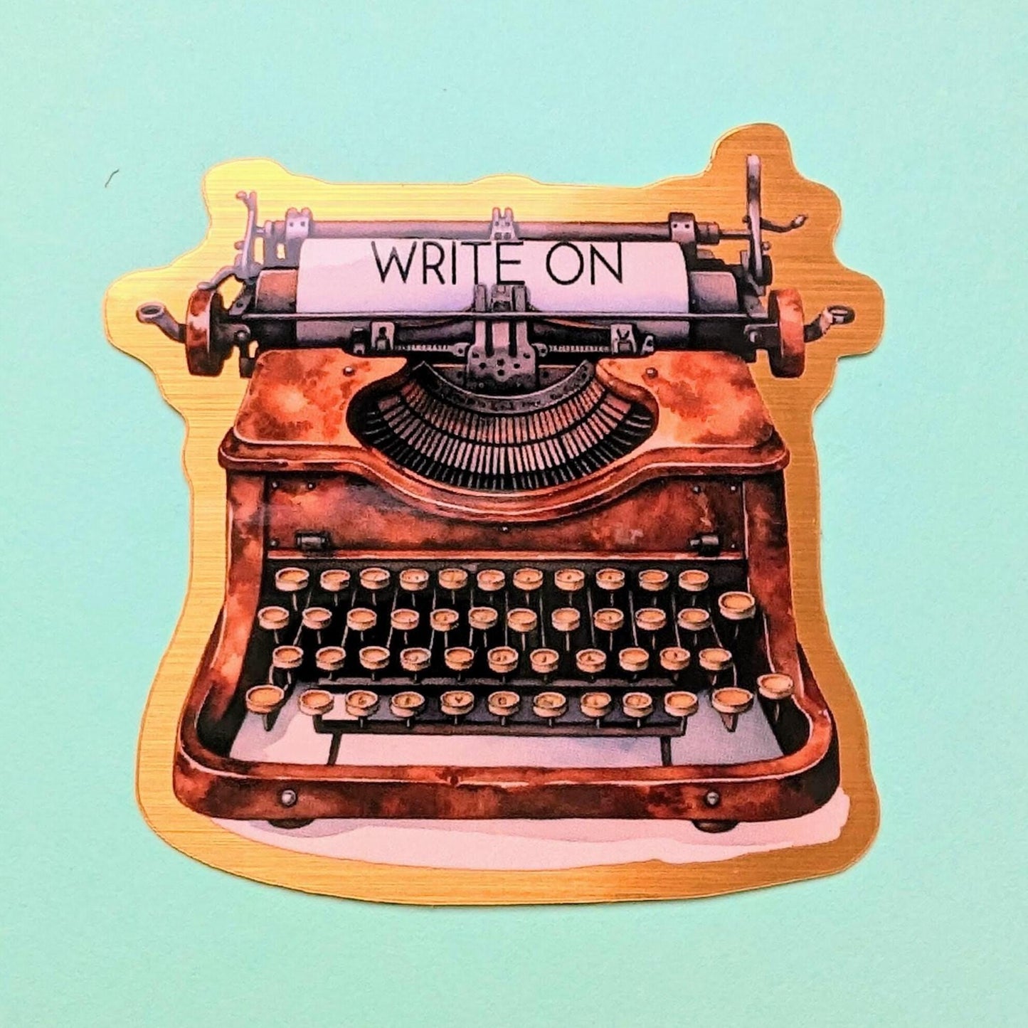 Write On Typewriter brushed gold die cut vinyl sticker